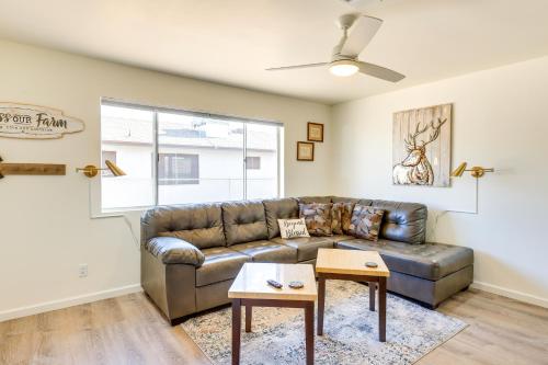 a living room with a leather couch and a table at Kingman Vacation Rental with Yard and Fire Pit in Kingman