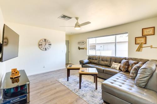 a living room with a couch and a tv at Kingman Vacation Rental with Yard and Fire Pit in Kingman