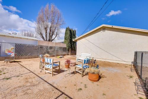two chairs and a table in a yard at Kingman Vacation Rental with Yard and Fire Pit in Kingman