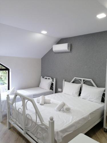 a bedroom with two beds with white pillows at Viva hotel Gabala with outdoor pool ,Sauna and Waterfall in Gabala