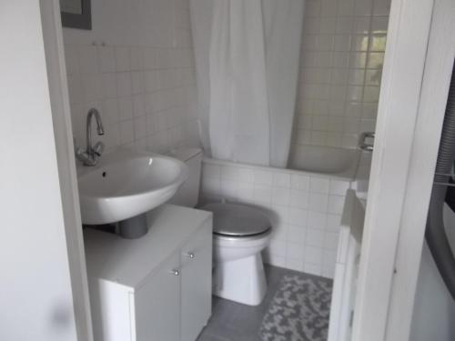 une salle de bain blanche avec un lavabo et des toilettes dans l'établissement Maisonnette de ville proche de la grande plage, à Saint-Malo
