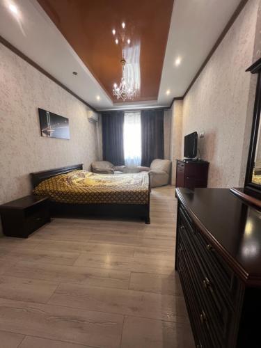 a large bedroom with a bed and a couch at Apartment on Dragomirova in Kyiv