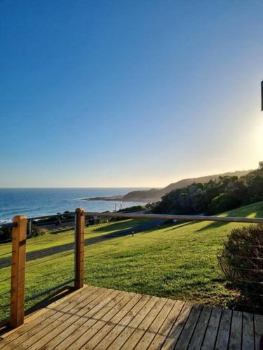 a wooden deck with a view of the ocean at 6 Whitecrest Great Ocean Road Resort - Ocean View in Apollo Bay
