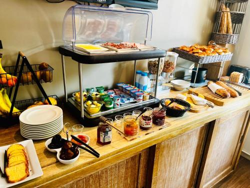 a buffet with a lot of food on a table at Hotel Douglas in Puteaux