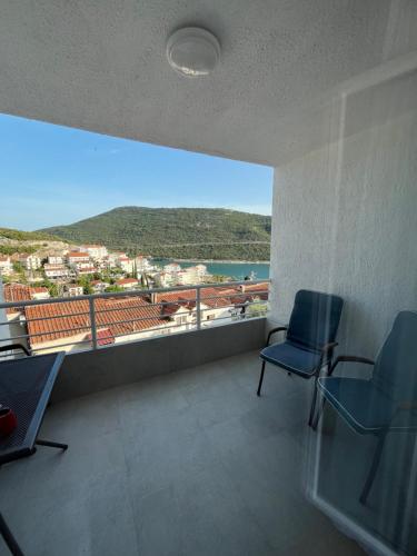 a room with two chairs and a view of the water at Apartment Darna in Neum