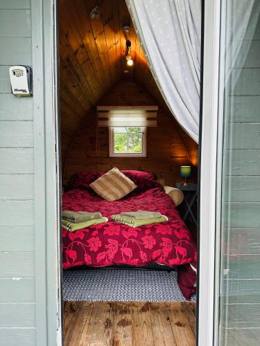 a bed in a small room in a house at Yule Tree Campsite in Helston