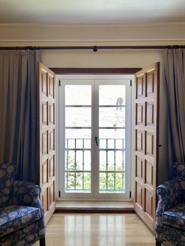 a large door with a window in a room at Parador de Vilalba in Villalba