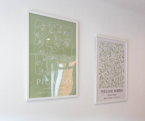 two framed posters hanging on a white wall at Moncrieff House in Livingston