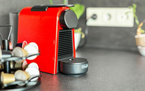 a hair brush sitting next to a red toaster at Lit Living Deluxe Apartments Wörth - Parking - Box Spring - BBQ - Balcony in Wörth am Rhein