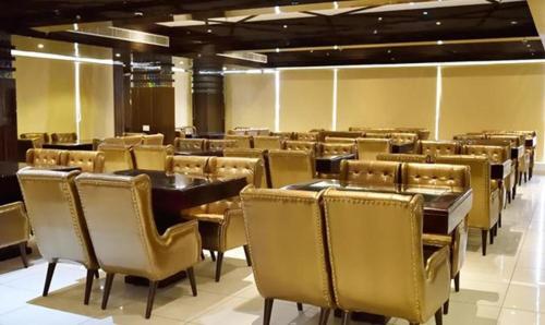 a dining room with tables and chairs in a building at FabHotel Prime Rester Select in Jodhpur