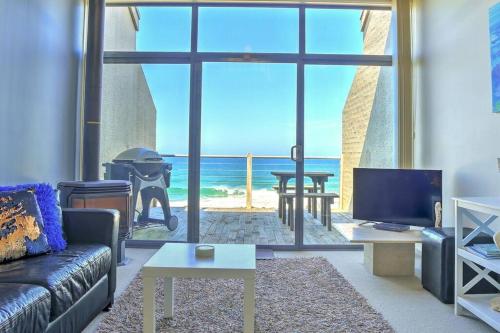 a living room with a couch and a view of the ocean at 11 Whitecrest Great Ocean Road Resort - Ocean View in Apollo Bay