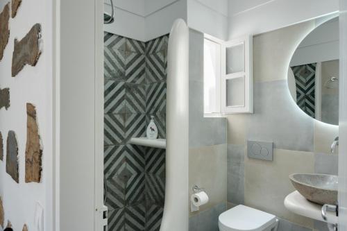 a bathroom with a toilet and a sink at Politimis Studio N2 in Amorgos