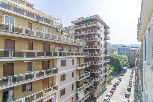 an apartment building with cars parked on a street at Lingotto District Functional Apartment in Turin