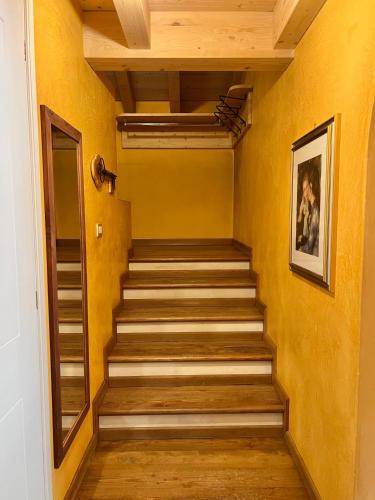 a staircase in a room with yellow walls at Appartamenti Forhotel in Livigno