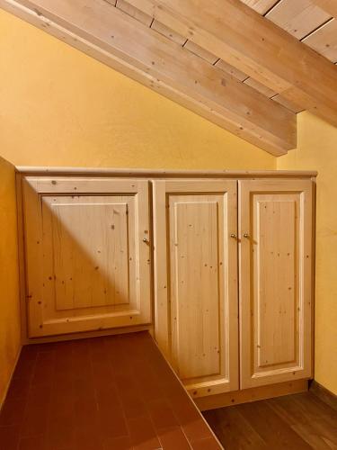 two wooden cabinets in a room with a ceiling at Appartamenti Forhotel in Livigno