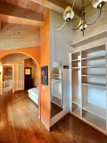a room with a bed and a room with shelves at Appartamenti Forhotel in Livigno