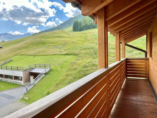 a balcony of a house with a view of a field at Appartamenti Forhotel in Livigno