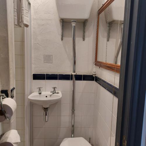 a small bathroom with a sink and a toilet at The Old Court House Guest House in Ross on Wye