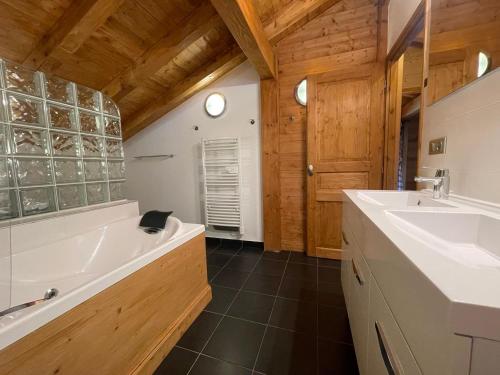 a bathroom with a tub and a sink at Chalet Savoyard avec Jardin, Poêle à Bois et WIFI - FR-1-624-11 in Verchaix