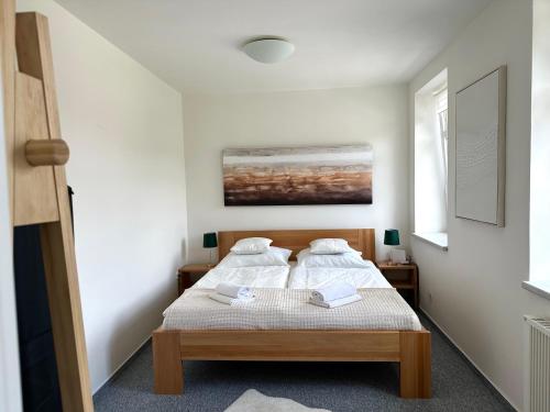 a bedroom with two beds and a painting on the wall at Na sjezdovce in Sedloňov