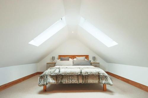 a bedroom with a bed in a attic at Cedar lodge - Hopewell in Bristol