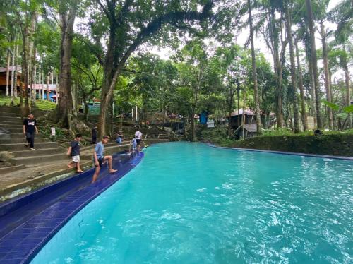 a group of children playing in a pool at a water park at Hakata Lejja near Natural Hot spring in Batu-Batu