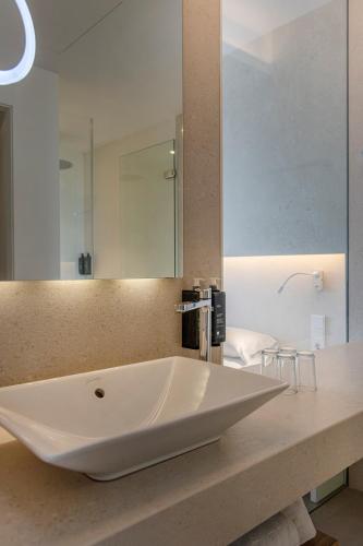 a bathroom with a large white sink on a counter at Bordoy Cosmopolitan in Playa de Palma