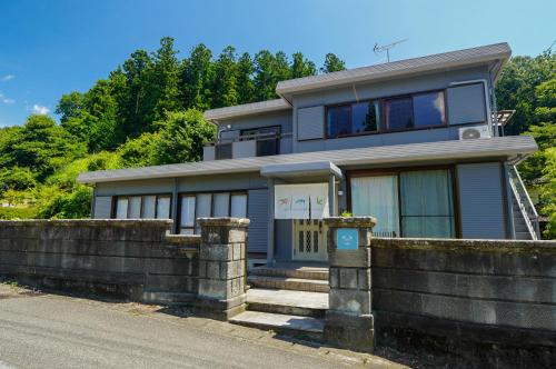 a house on a hill with a fence at Nikko Holiday Home Sumica in Nikko