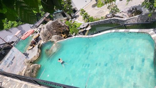 an overhead view of a man in a swimming pool at Lotus Premium Lodge - Lotus Group Tours in Ha Giang