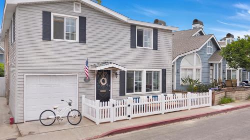a white bike parked in front of a house at 122 Thirty Third Street in Newport Beach