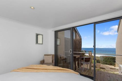 a bedroom with a bed and a view of the ocean at 9 Whitecrest Great Ocean Road Resort - Ocean View in Apollo Bay