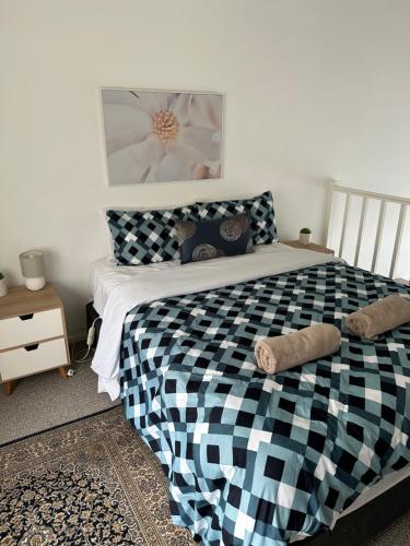 a bedroom with a black and white checkered bed at 9 Whitecrest Great Ocean Road Resort - Ocean View in Apollo Bay