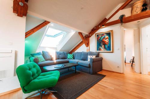 a living room with a couch and a table at Spacious Penthouse with AC and Free Parking Steps Away From the Central Station in Koblenz