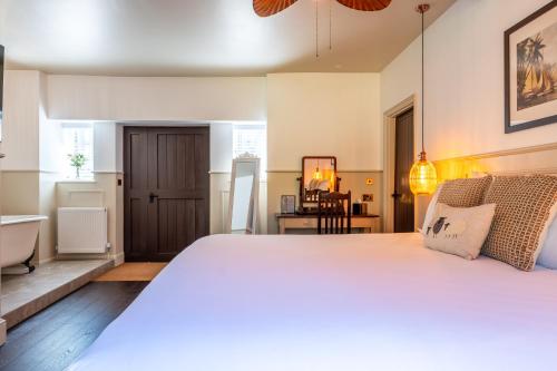 a bedroom with a large bed and a bathroom at Woolpack Inn in Canterbury