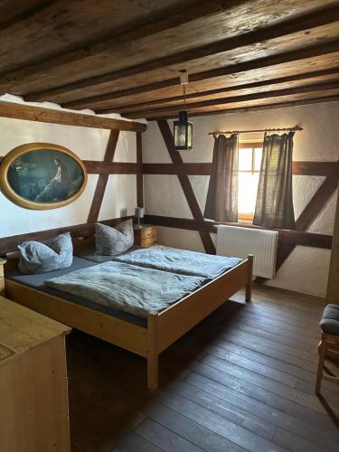 a bedroom with a large bed in a attic at Altstadtpension Zirndorf in Zirndorf