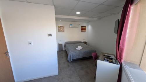 Postel nebo postele na pokoji v ubytování Tres Arroyos Suite