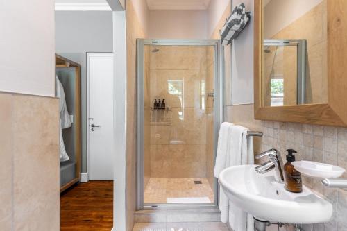 a bathroom with a shower and a sink at Camps Bay Forest Pods in Cape Town