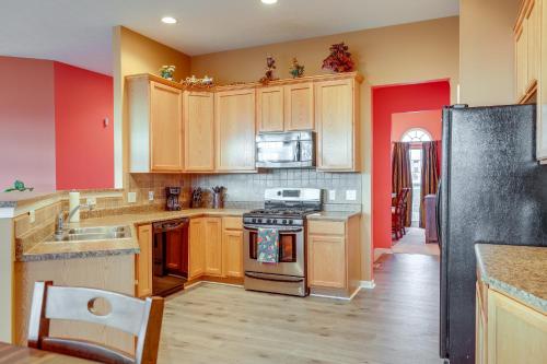 a kitchen with wooden cabinets and a stove top oven at Family Home Near Beach about 6 Mi to Dtwn Canandaigua in Canandaigua