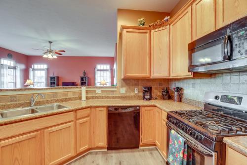 a kitchen with wooden cabinets and a stove top oven at Family Home Near Beach about 6 Mi to Dtwn Canandaigua in Canandaigua