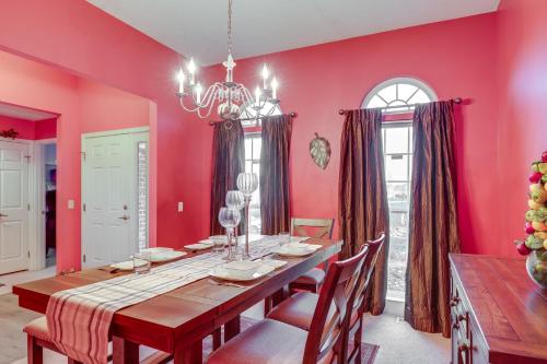 a dining room with pink walls and a table and chairs at Family Home Near Beach about 6 Mi to Dtwn Canandaigua in Canandaigua