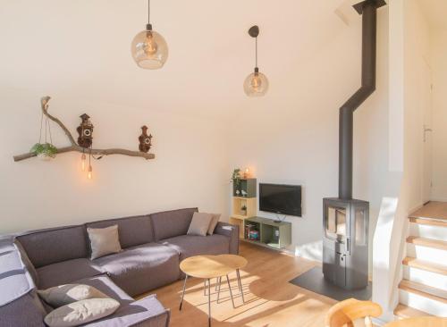 a living room with a couch and a wood stove at Loohuisje 43 in Aalten