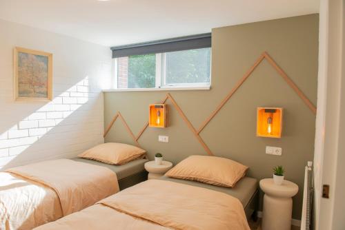 two twin beds in a room with stairs at Loohuisje 43 in Aalten