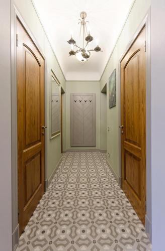 an empty hallway with two doors and a hallway with a tile floor at Quiet garden deluxe apartment in Rīga