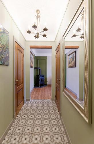 a hallway with two doors and a mirror at Quiet garden deluxe apartment in Rīga