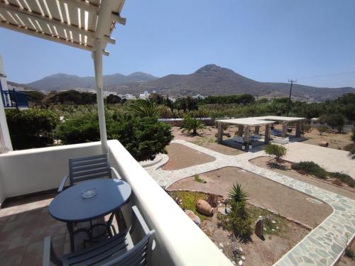 a patio with a table and chairs on a balcony at Villa Le Grand Bleu in Katapola