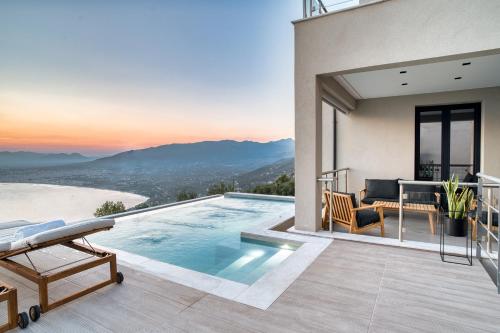 a villa with a swimming pool and a patio at Kalma Luxury Villas in Kalamata