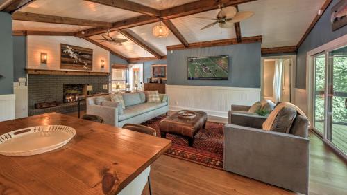 a living room with a couch and a table at Treehouse on the Lake in Blairsville