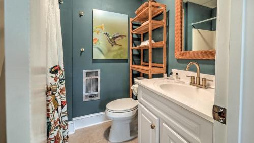 a bathroom with a white toilet and a sink at Treehouse on the Lake in Blairsville