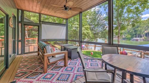 a screened in porch with a table and chairs at Treehouse on the Lake in Blairsville