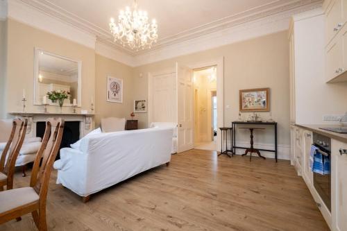 a living room with a white couch and a table at Host & Stay - Brunswick Sea View in Brighton & Hove